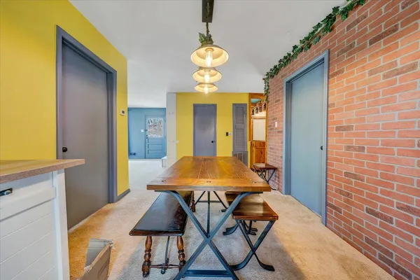 a view of a dining room with furniture and chandelier
