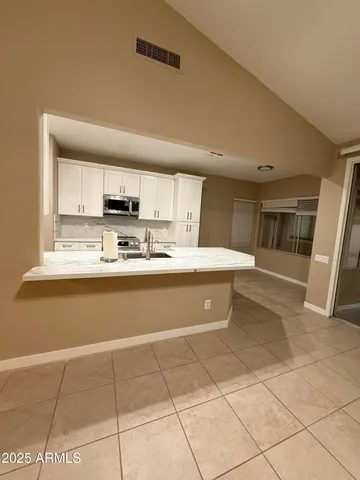 a view of empty room with a fireplace and windows