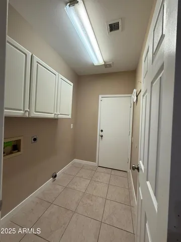 a view of a room with an empty space and windows