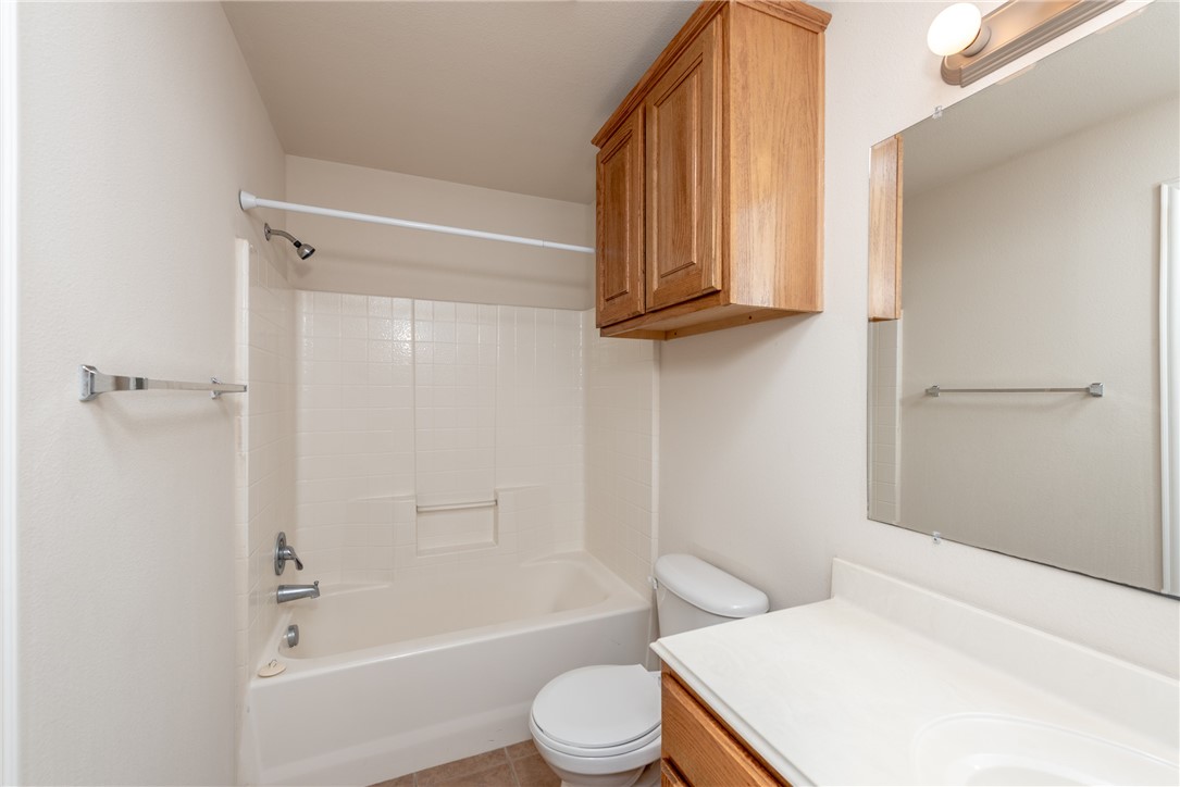 1001 Krenek Tap Road, Unit 1102 College Station, TX 77840 - Photo 18 of 26 a bathroom with a sink a toilet and shower