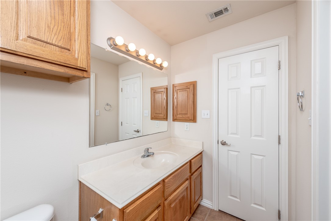 1001 Krenek Tap Road, Unit 1102 College Station, TX 77840 - Photo 19 of 26 a bathroom with a sink and a mirror