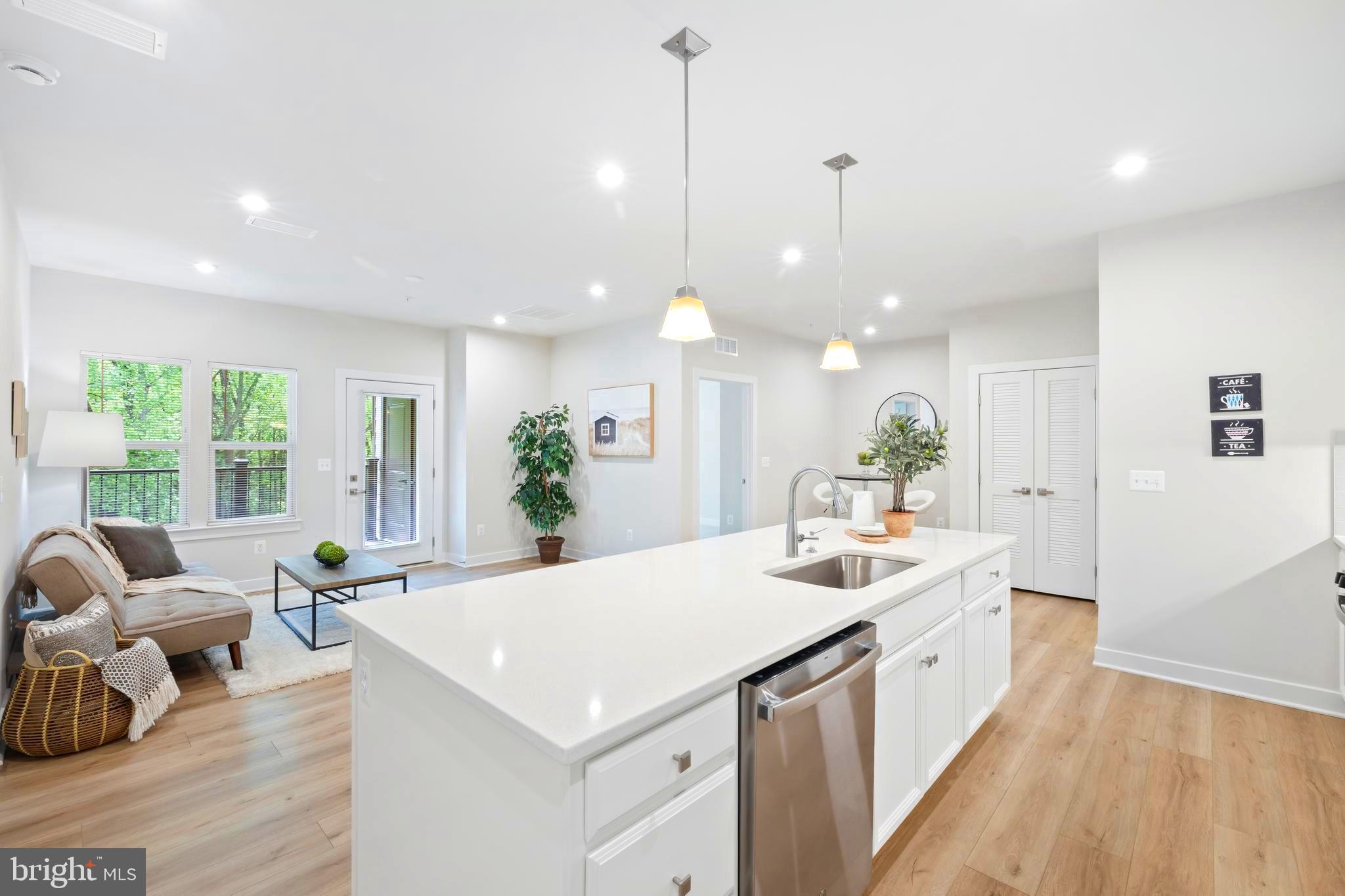 10391 Resort Road, Unit Q Ellicott City, MD 21042 - Photo 4 of 24 a view of a kitchen island furniture wooden floor and a chandelier