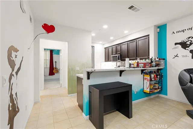 a kitchen view with stainless steel appliances kitchen island granite countertop a stove and a refrigerator