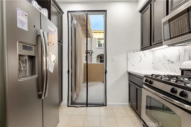a kitchen with stainless steel appliances granite countertop a refrigerator and a stove