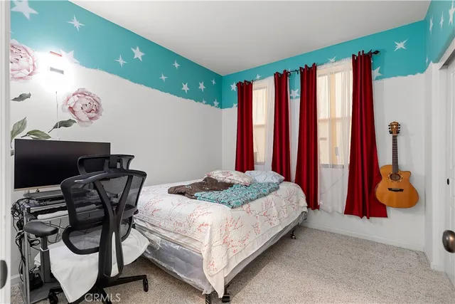 a bedroom with a bed and cabinets