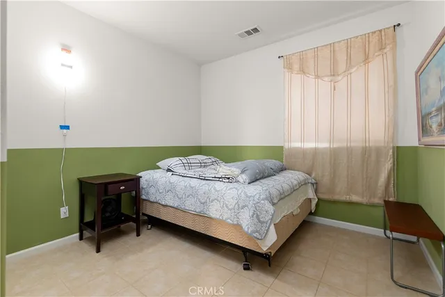 a bedroom with a bed and a chair