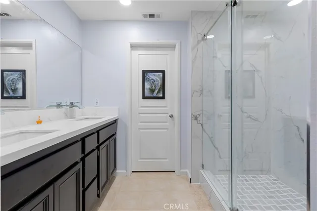 a bathroom with a sink a mirror and a shower