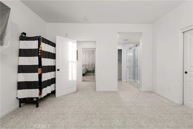 a view of empty room with white walls