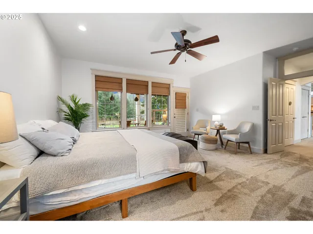 a bedroom with a bed couch and window