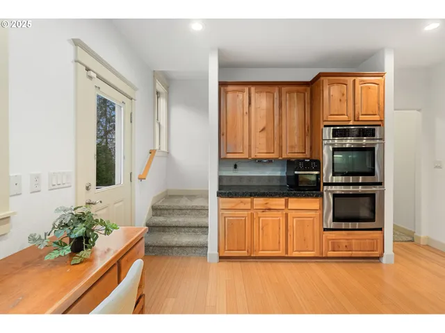 a kitchen with granite countertop a stove and a refrigerator