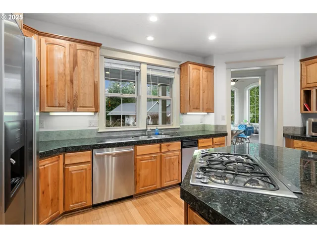 a kitchen with granite countertop a stove and a sink