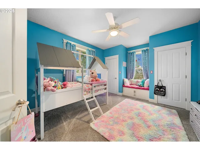 a living room with furniture and a baby crib