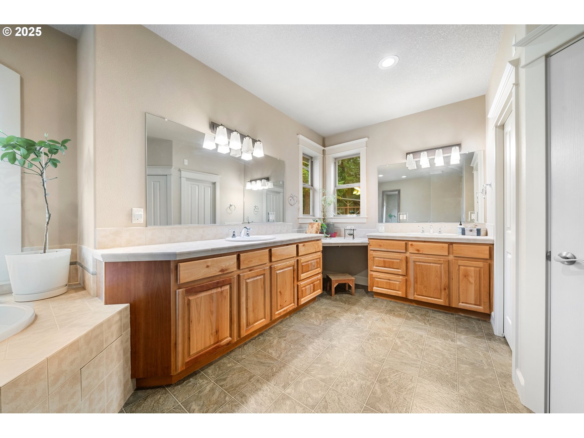 30180 Carrico Valley Road St. Helens, OR 97051 - Photo 28 of 48 a large bathroom with a double vanity sink a large mirror and a bathtub