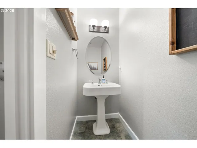 a view of a bathroom with a sink and a mirror