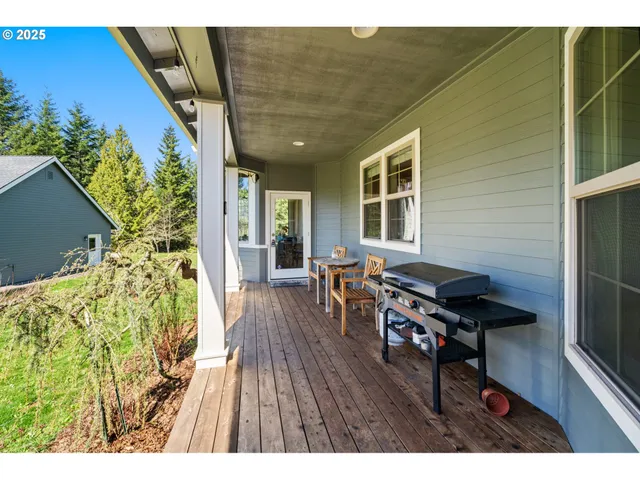 a balcony with wooden floor and outdoor seating
