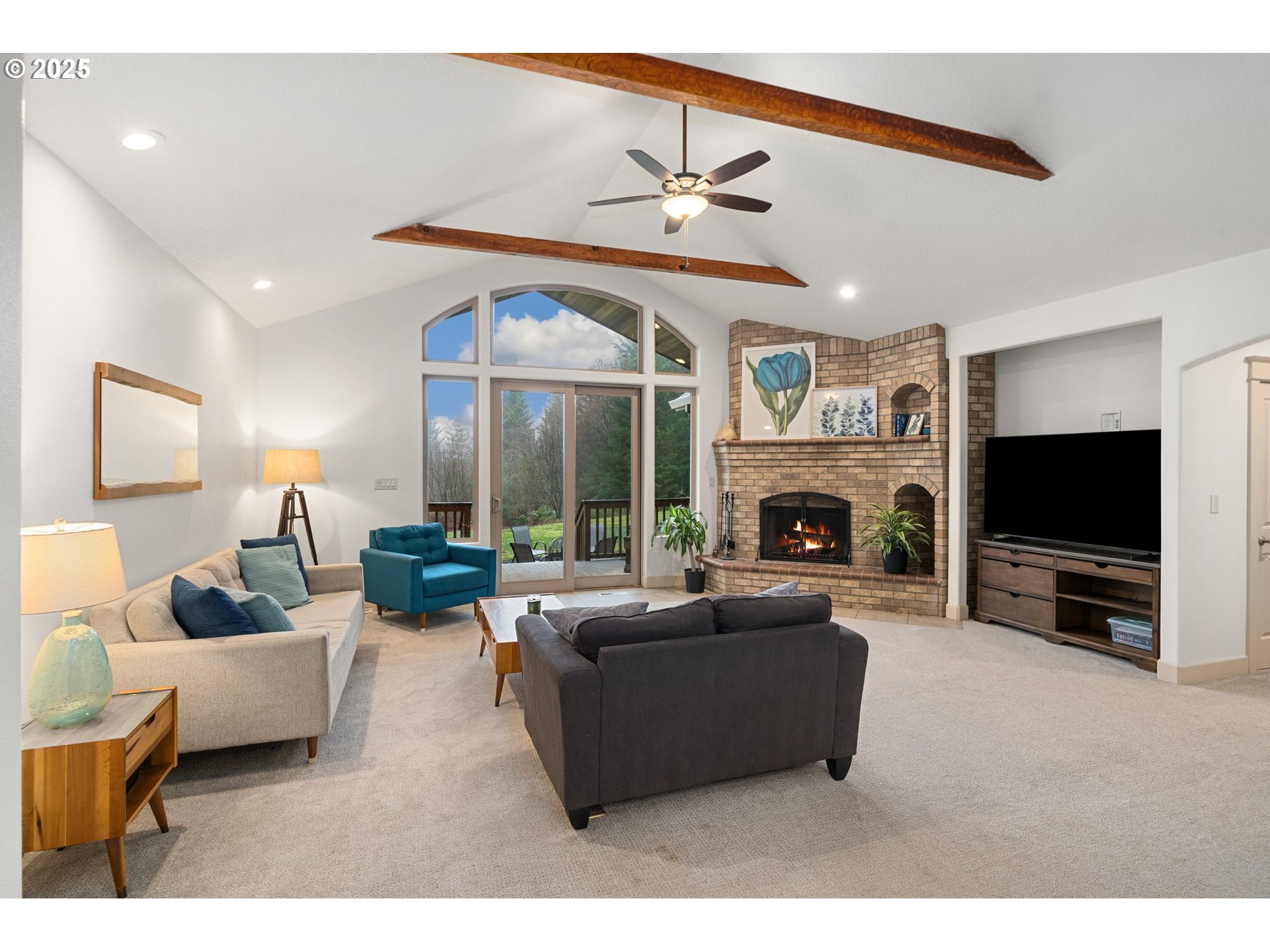 30180 Carrico Valley Road St. Helens, OR 97051 - Photo 10 of 48 a living room with furniture a fireplace and a flat screen tv