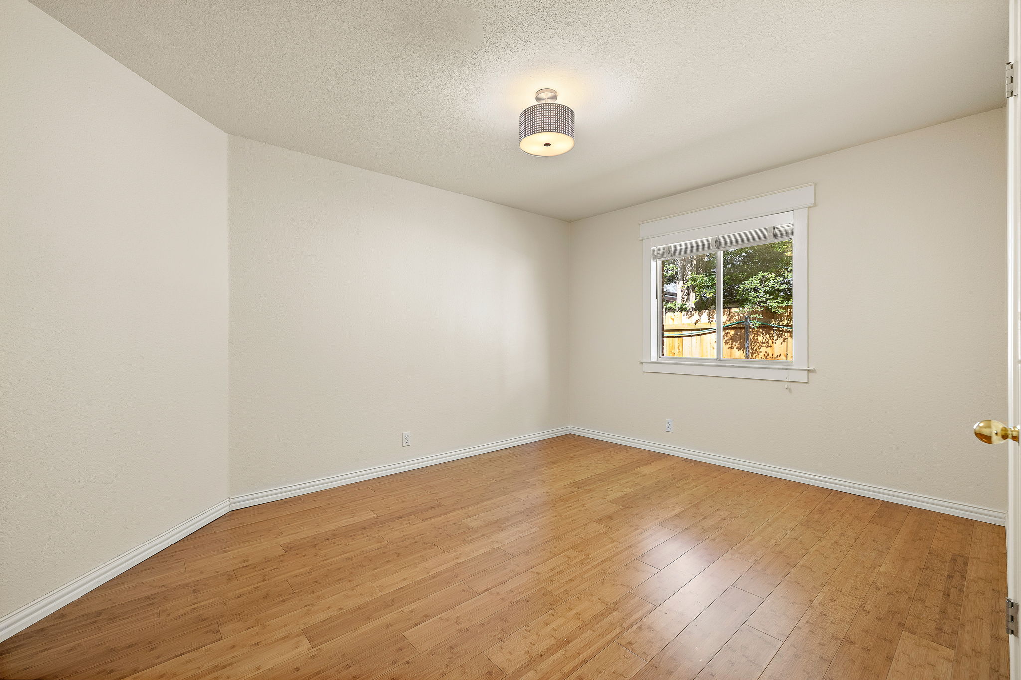 1102 Nelson Ranch Road Cedar Park, TX 78613 - Photo 28 of 37 Golden hardwood floors extend across this naturally illuminated bedroom with a window offering views of green foliage.