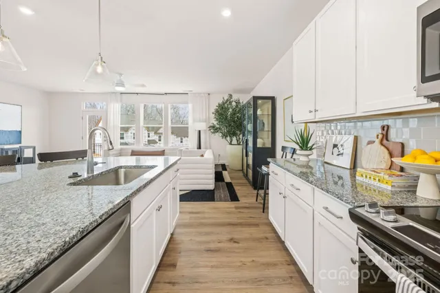 a kitchen with stainless steel appliances granite countertop a sink and stove