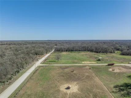 a view of a swimming pool and a yard