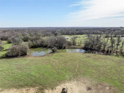 a view of a field with an ocean view