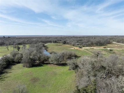 an aerial view of field and trees