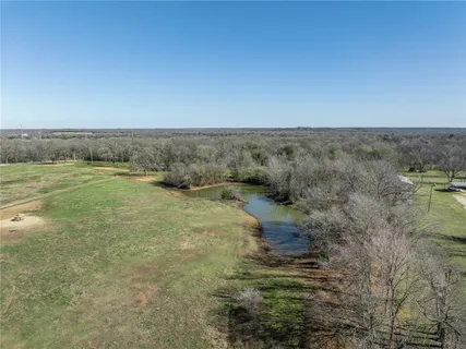 a view of a field with an ocean