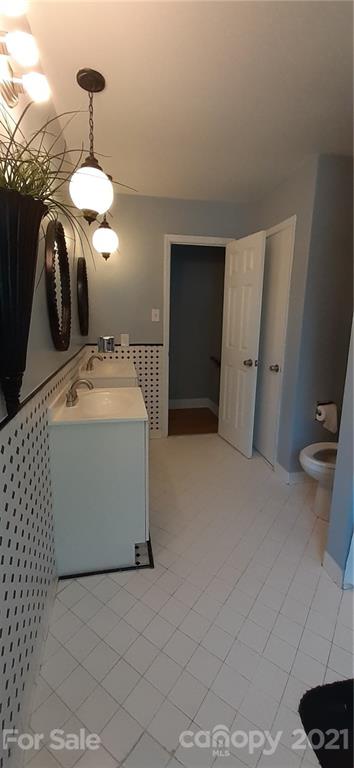 5111 Lodestone Road Charlotte, NC 28215 - Photo 13 of 19 a bathroom with a sink and a mirror