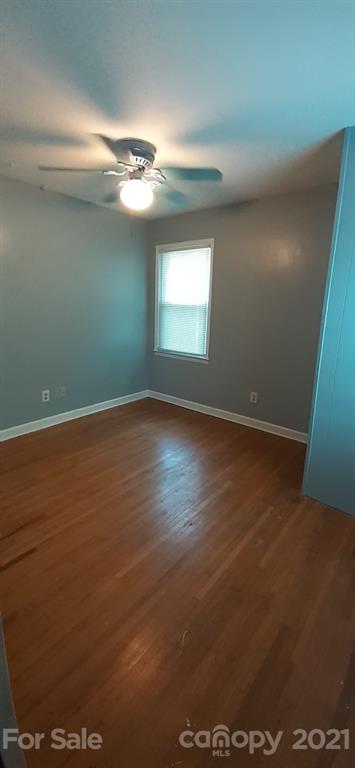 5111 Lodestone Road Charlotte, NC 28215 - Photo 16 of 19 an empty room with wooden floor and windows