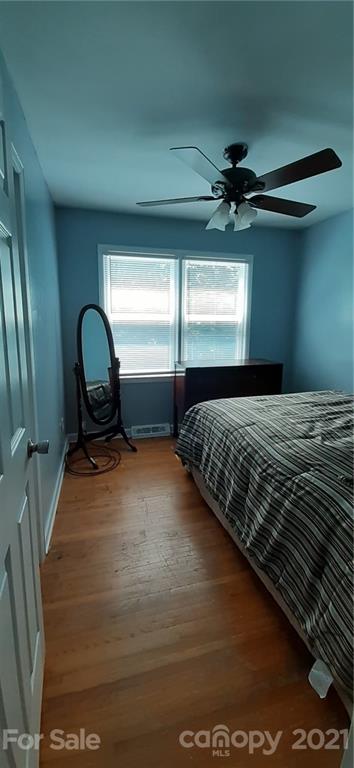 5111 Lodestone Road Charlotte, NC 28215 - Photo 19 of 19 a bedroom with a bed and a dresser next to a window