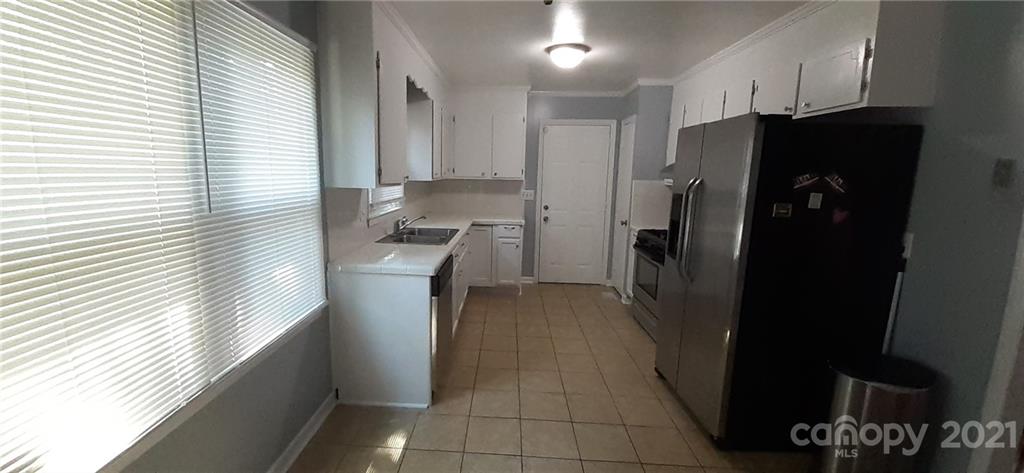 5111 Lodestone Road Charlotte, NC 28215 - Photo 3 of 19 a kitchen with a refrigerator and a sink