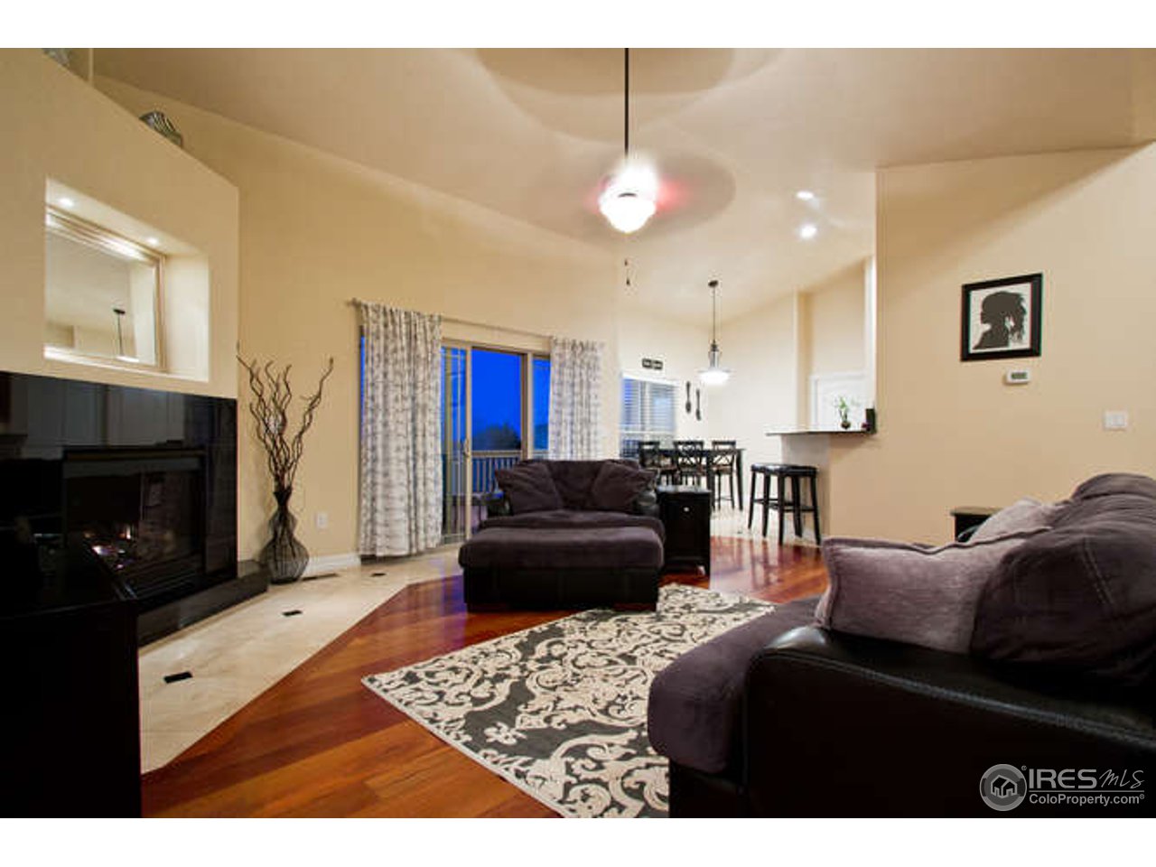 7737 Poudre River Road Greeley, CO 80634 - Photo 6 of 20 Gas fireplace and large, open spaces