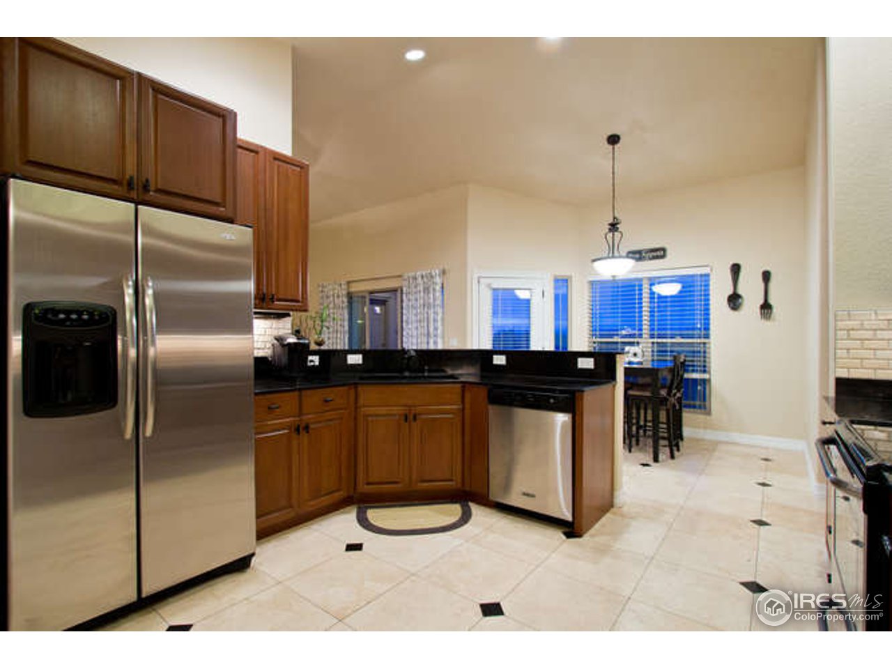 7737 Poudre River Road Greeley, CO 80634 - Photo 7 of 20 Large eat-in kitchen with granite and cherry cabs