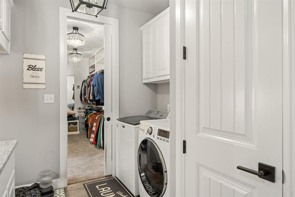 1800 Knox Road Tolar, TX 76476 - Photo 13 of 38 Dedicated laundry area featuring a built-in upper cabinet, a front-loading washing machine, and a top-loading dryer