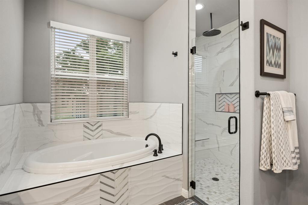 1800 Knox Road Tolar, TX 76476 - Photo 17 of 38 Spacious bathroom featuring a built-in soaking tub with matte black fixtures and a window with horizontal blinds