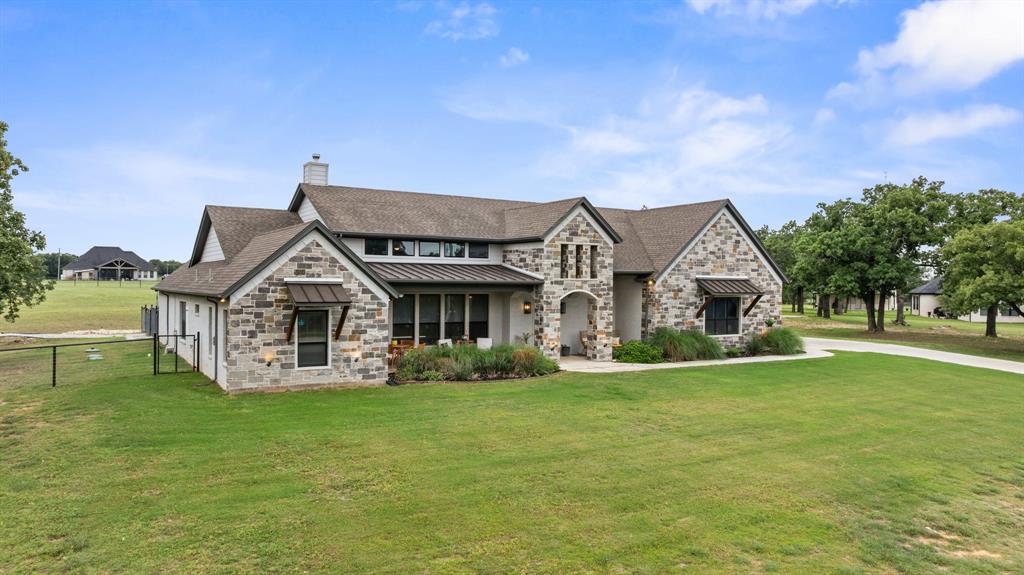 1800 Knox Road Tolar, TX 76476 - Photo 2 of 38 Stone and brick exterior with a prominent arched entry