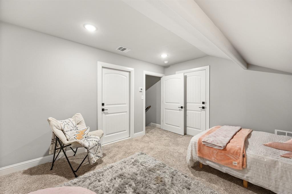 1800 Knox Road Tolar, TX 76476 - Photo 26 of 38 Bedroom #5/Bonus room featuring an angled ceiling with exposed beams, recessed lighting, and white paneled doors with dark hardware