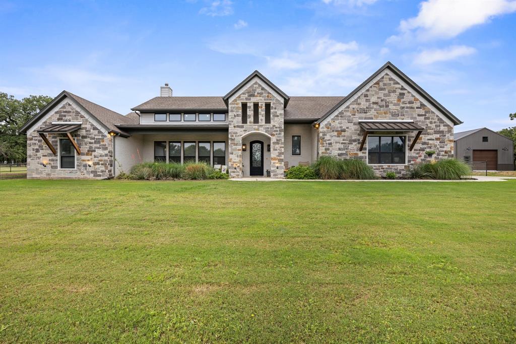 1800 Knox Road Tolar, TX 76476 - Photo 5 of 38 Stone and brick exterior featuring a prominent arched entryway and multiple roof gables
