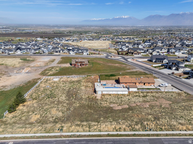 296 West Olympic Lane, Unit 2 Elk Ridge, UT 84651 - Photo 4 of 14 Aerial view of property and surrounding area with nearby suburban area and a mountain backdrop