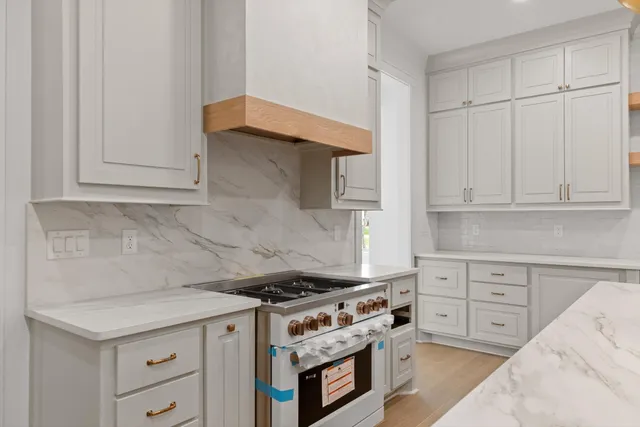 a kitchen with cabinets appliances and wooden floor