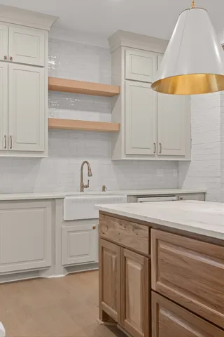 a kitchen with white cabinets and a sink