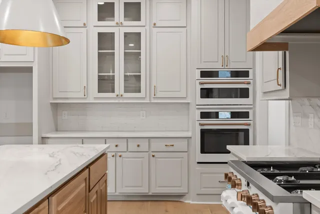 a kitchen with stainless steel appliances granite countertop a stove and a microwave