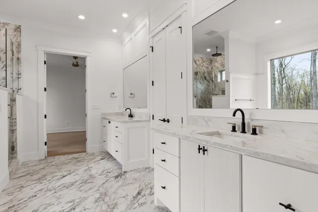 a spacious bathroom with double sink and a mirror