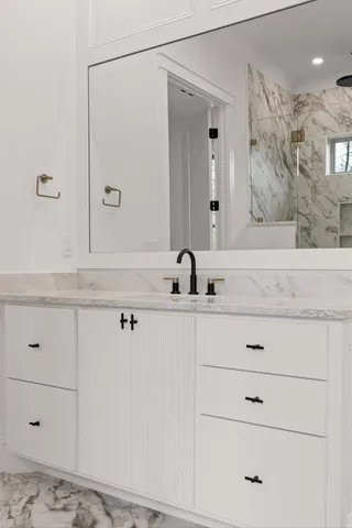 a bathroom with a sink and mirror
