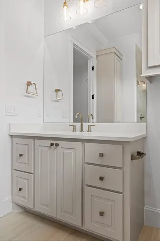 a bathroom with a sink vanity and a mirror