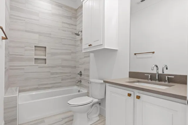 a bathroom with a sink a toilet and bathtub