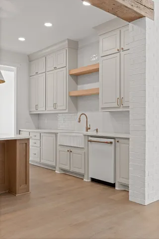 a kitchen with white cabinets and white appliances