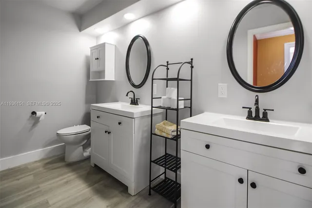 a bathroom with a toilet a sink and a mirror