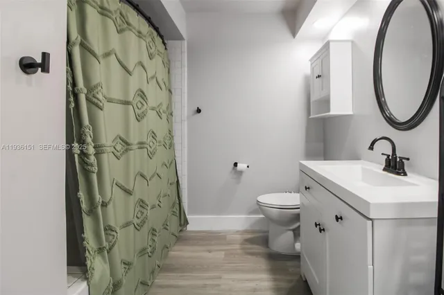 a bathroom with a toilet sink and a mirror
