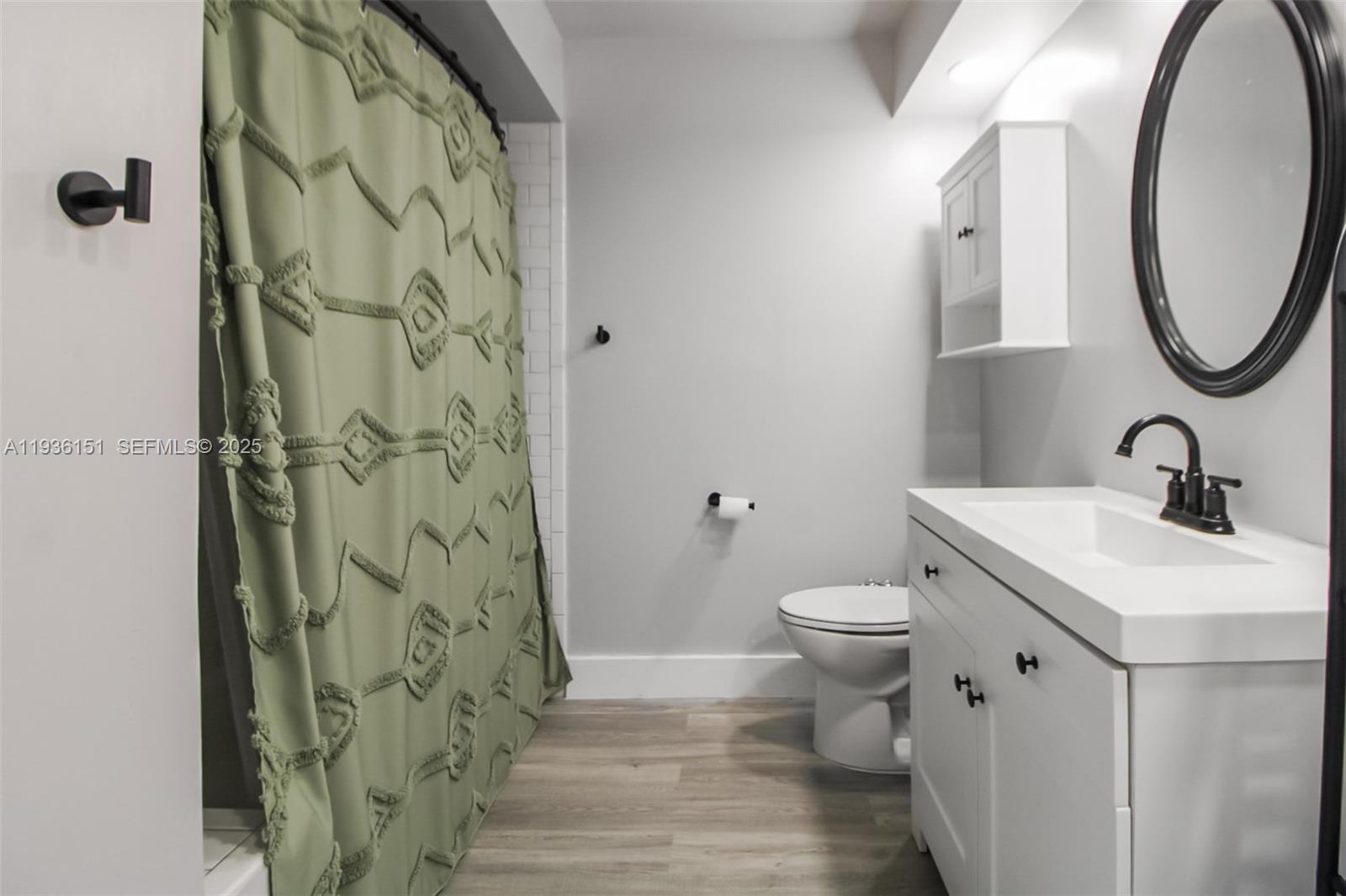 4235 Southwest 148th Place Miami, FL 33185 - Photo 15 of 23 a bathroom with a toilet sink and a mirror