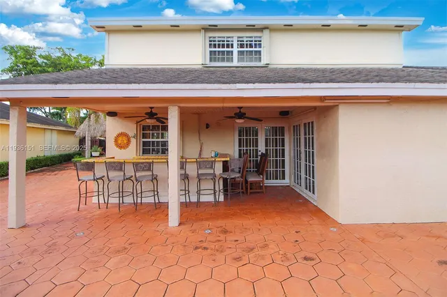 a backyard of a house with table and chairs